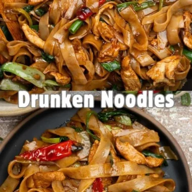 Delicious plate of drunken noodles garnished with vegetables and herbs