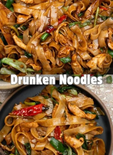 Delicious plate of drunken noodles garnished with vegetables and herbs