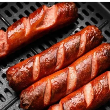 Delicious air fryer hot dogs served with condiments on a plate