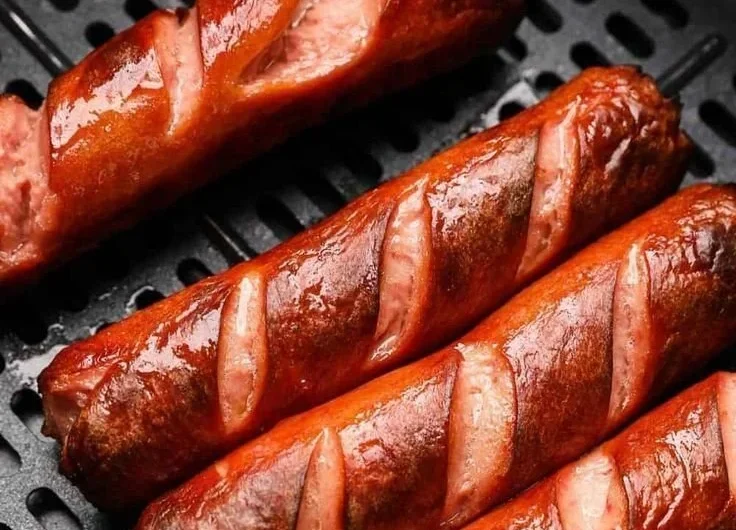 Delicious air fryer hot dogs served with condiments on a plate