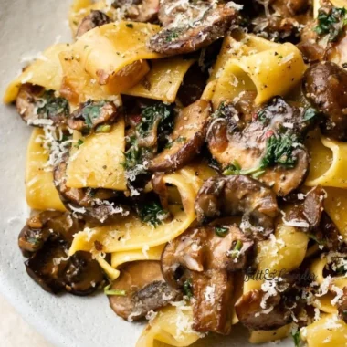Easy garlic mushroom pasta dish garnished with parsley and parmesan cheese