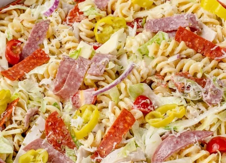 Colorful Grinder Pasta Salad with vegetables and dressing in a bowl