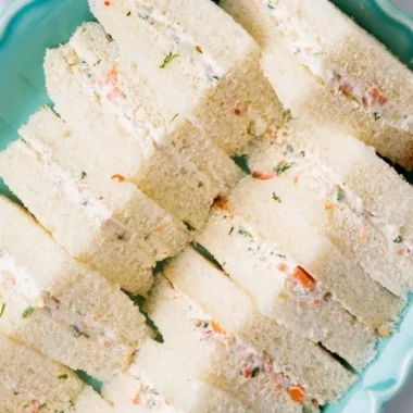 Veggie cream cheese finger sandwiches on a platter