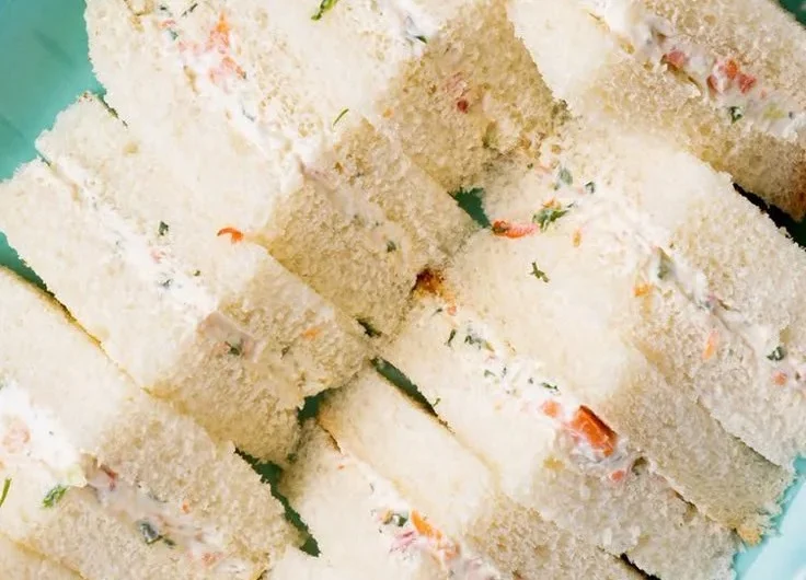Veggie cream cheese finger sandwiches on a platter