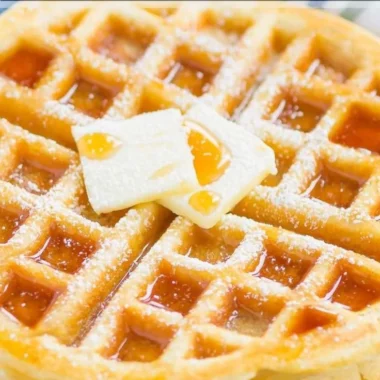 Delicious fluffy Belgian waffles topped with fresh berries and whipped cream