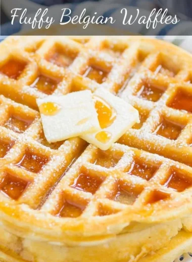 Delicious fluffy Belgian waffles topped with fresh berries and whipped cream