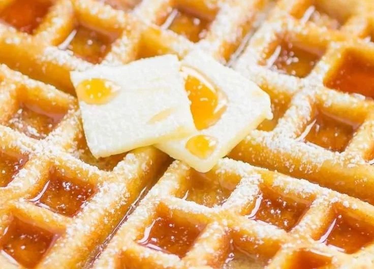 Delicious fluffy Belgian waffles topped with fresh berries and whipped cream