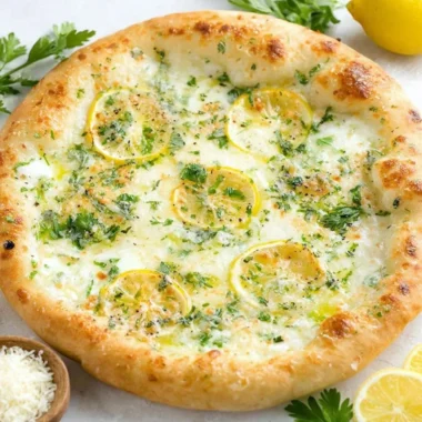 Lemon pizza topped with fresh herbs and cheese