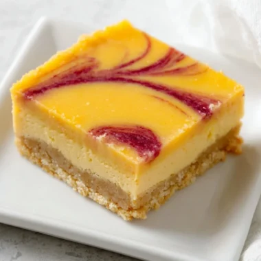 Delicious mango curd bars served on a plate with fresh mango slices.
