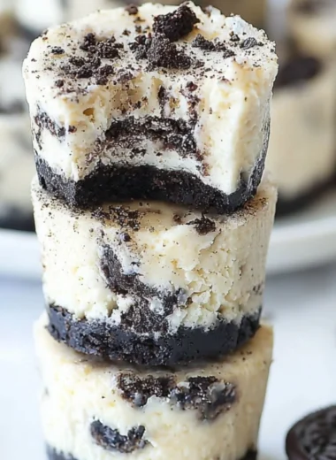 Delicious Mini Oreo Cheesecakes topped with crushed Oreos.