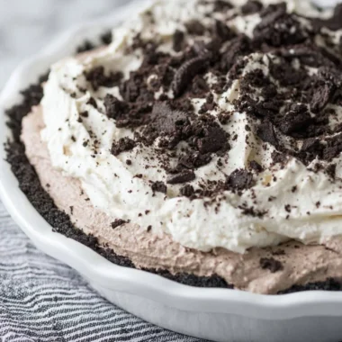 Delicious Oreo Pudding Pie topped with cream and crushed Oreos
