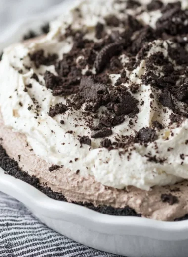 Delicious Oreo Pudding Pie topped with cream and crushed Oreos