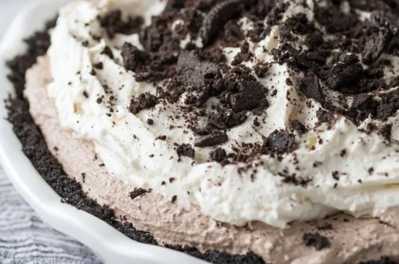 Delicious Oreo Pudding Pie topped with cream and crushed Oreos