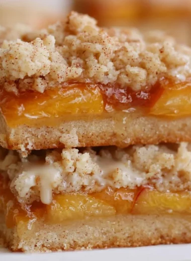 Delicious homemade peach bars topped with fresh peach slices