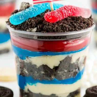Red, White and Blue Dirt Cups dessert with layers of dirt and whipped cream