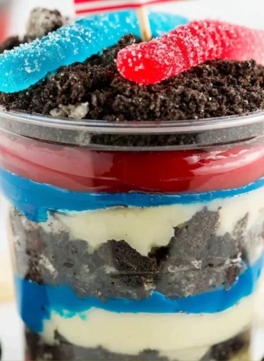 Red, White and Blue Dirt Cups dessert with layers of dirt and whipped cream