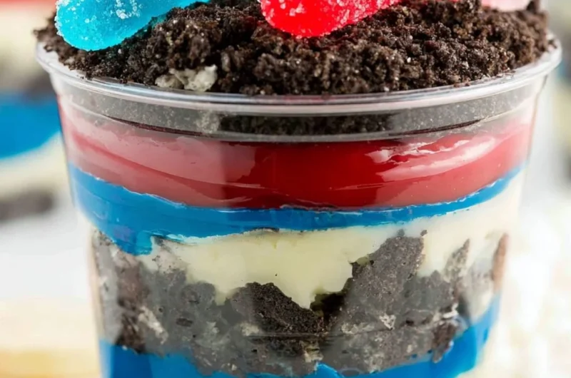 Red, White and Blue Dirt Cups dessert with layers of dirt and whipped cream