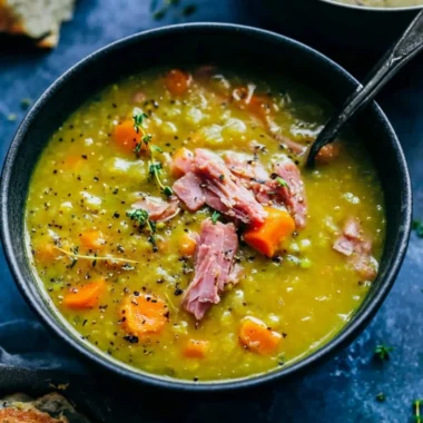 Bowl of homemade split pea soup garnished with herbs