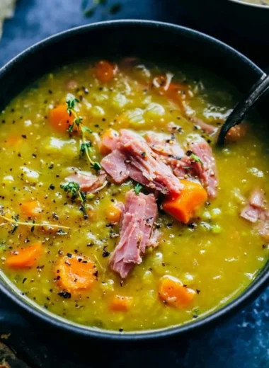 Bowl of homemade split pea soup garnished with herbs