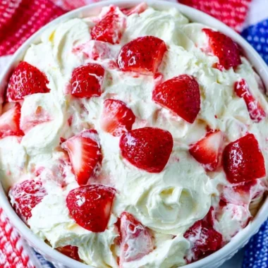 Bowl of colorful Summer Cheesecake Salad with fresh fruits and creamy cheesecake dressing.