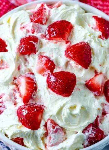 Bowl of colorful Summer Cheesecake Salad with fresh fruits and creamy cheesecake dressing.