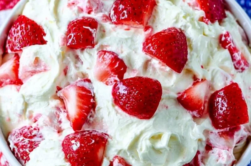Bowl of colorful Summer Cheesecake Salad with fresh fruits and creamy cheesecake dressing.