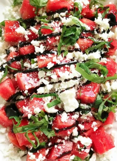 Watermelon salad with feta cheese on a plate garnished with mint leaves
