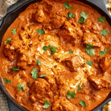 Delicious chicken tikka masala dish served with rice and naan bread.