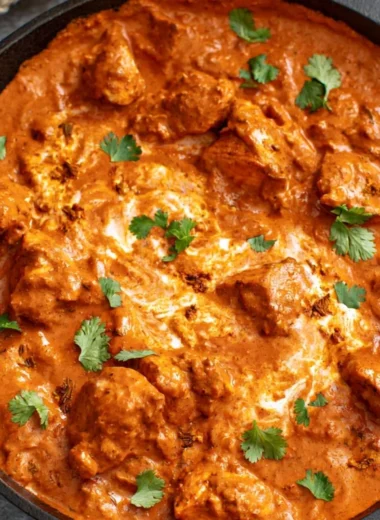 Delicious chicken tikka masala dish served with rice and naan bread.