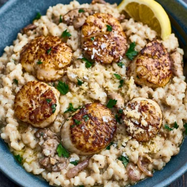 Delicious scallops risotto served in a cozy atmosphere for an evening meal