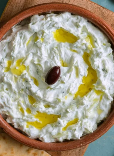 Delicious Greek tzatziki served with fresh vegetables and pita bread
