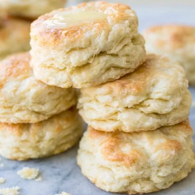 Freshly baked biscuits on a wooden table, showcasing the best biscuit recipe.