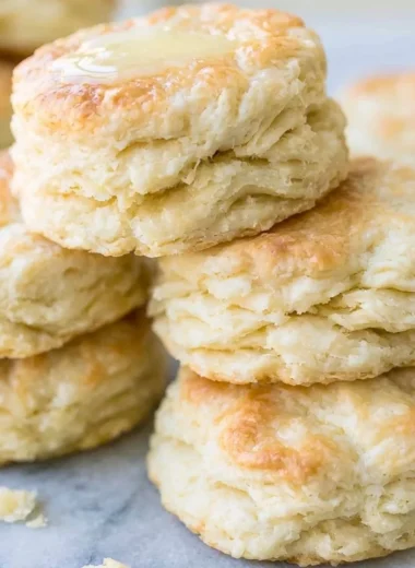 Freshly baked biscuits on a wooden table, showcasing the best biscuit recipe.