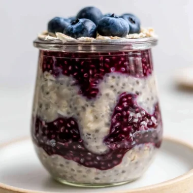 Bowl of blueberry overnight oats topped with fresh blueberries and almonds