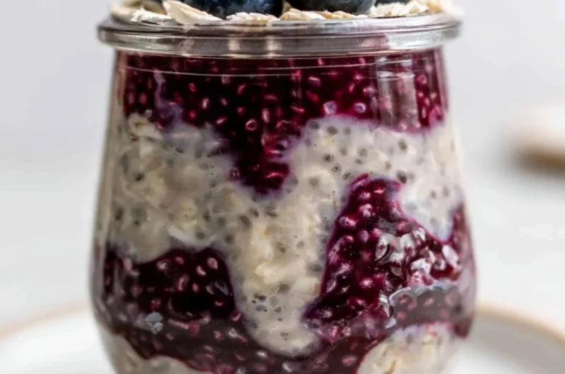 Bowl of blueberry overnight oats topped with fresh blueberries and almonds