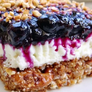 Delicious Blueberry Pretzel Salad served in a vibrant bowl, showcasing layers of flavors.