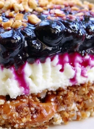 Delicious Blueberry Pretzel Salad served in a vibrant bowl, showcasing layers of flavors.