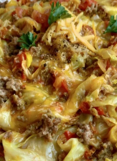 Delicious cabbage roll skillet served in a bowl with vibrant vegetables and sauce.