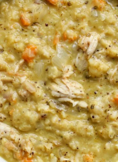 Bowl of creamy cauliflower chicken soup with herbs and spices
