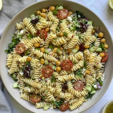 Cozy Vegan Greek Pasta Salad with fresh vegetables and herbs.