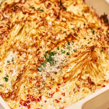 Creamy garlic butter cabbage dish served in a bowl with herbs