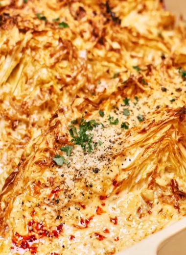 Creamy garlic butter cabbage dish served in a bowl with herbs