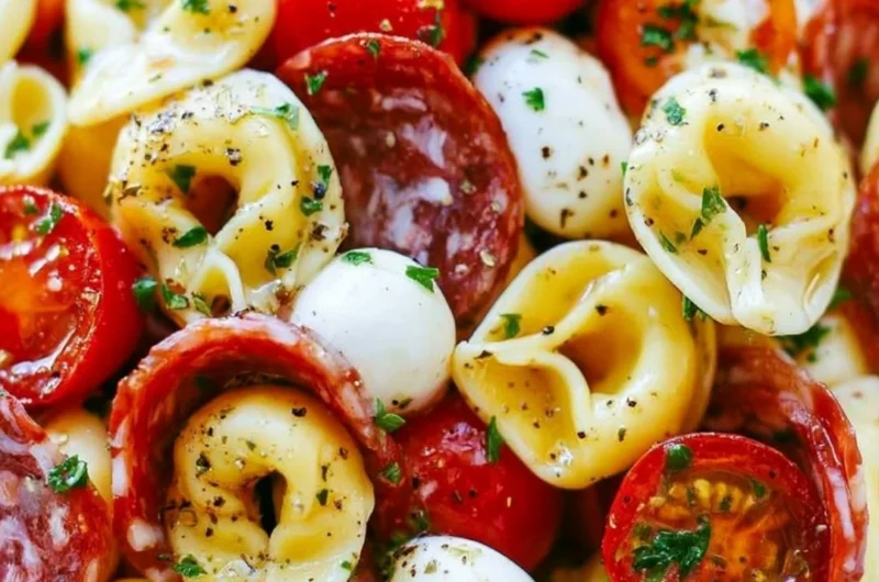Roasted Red Pepper and Parmesan Tortellini Salad served in a bowl