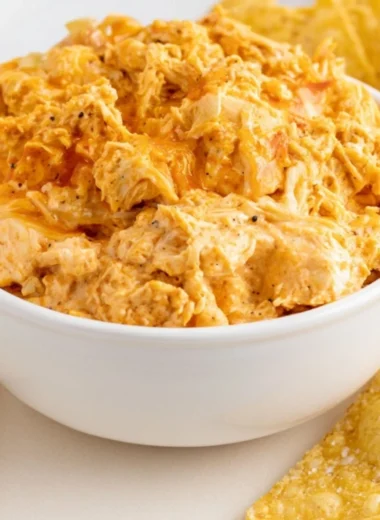 Delicious smoked buffalo chicken dip served in a bowl with chips