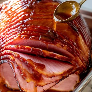 Delicious brown sugar ham glaze drizzled over a baked holiday ham.