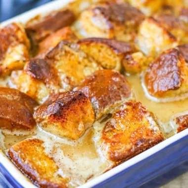 Delicious cozy bread pudding served warm with a drizzle of caramel sauce
