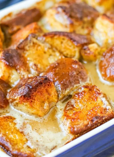 Delicious cozy bread pudding served warm with a drizzle of caramel sauce