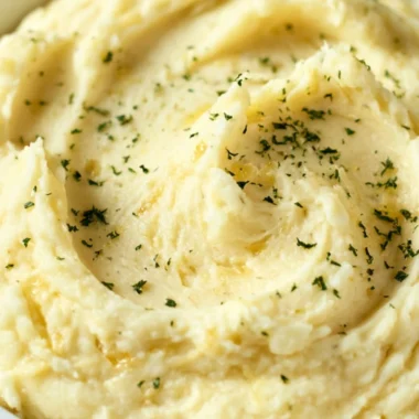 Cozy garlic mashed potatoes served in a bowl with herbs.