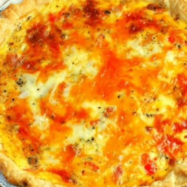 Slice of easy bacon cheese quiche on a plate